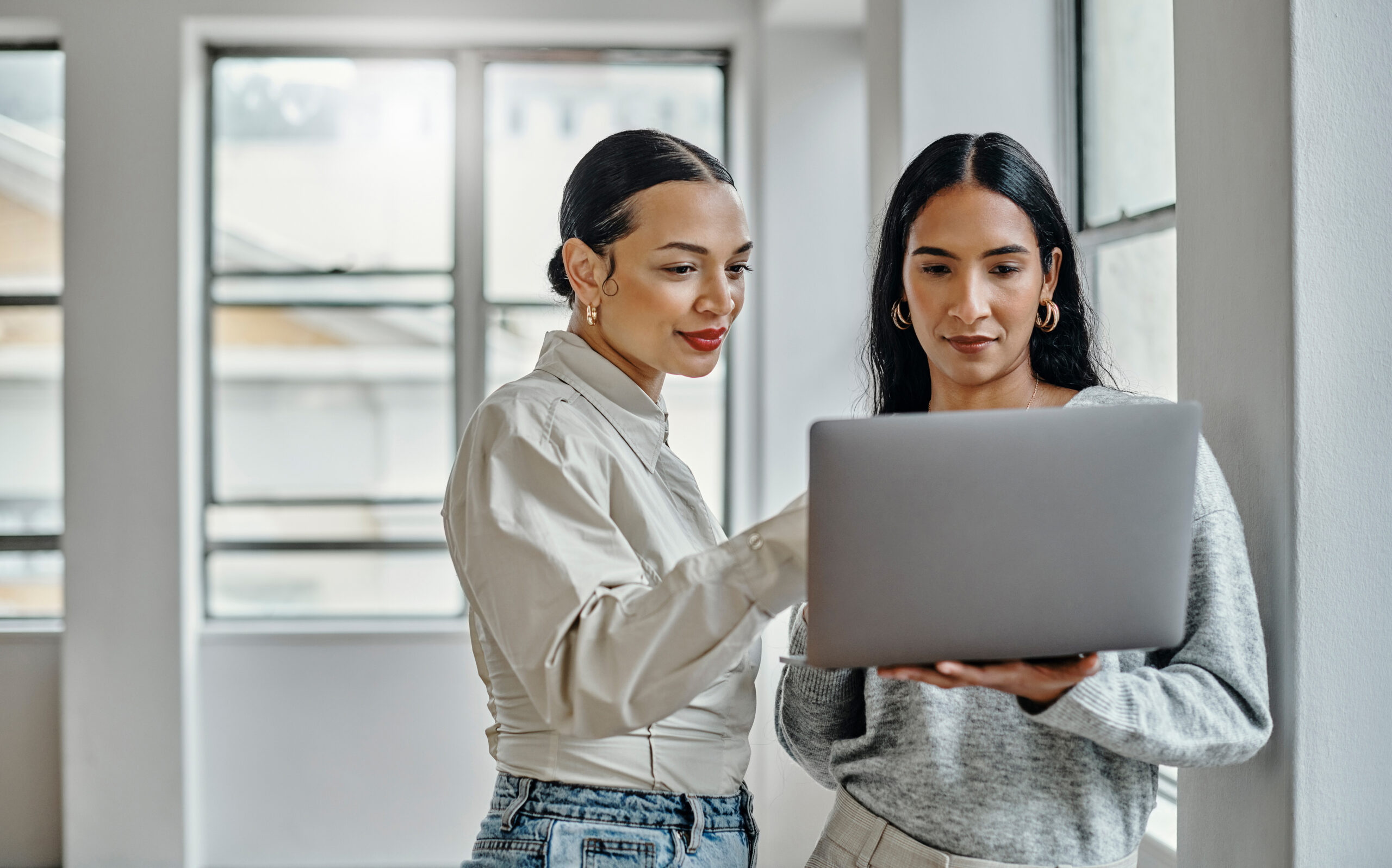 Laptop, women and digital marketing employees on a blog website working on cool trendy online fashion content. Branding, teamwork and social media page editors researching current trendy post ideas